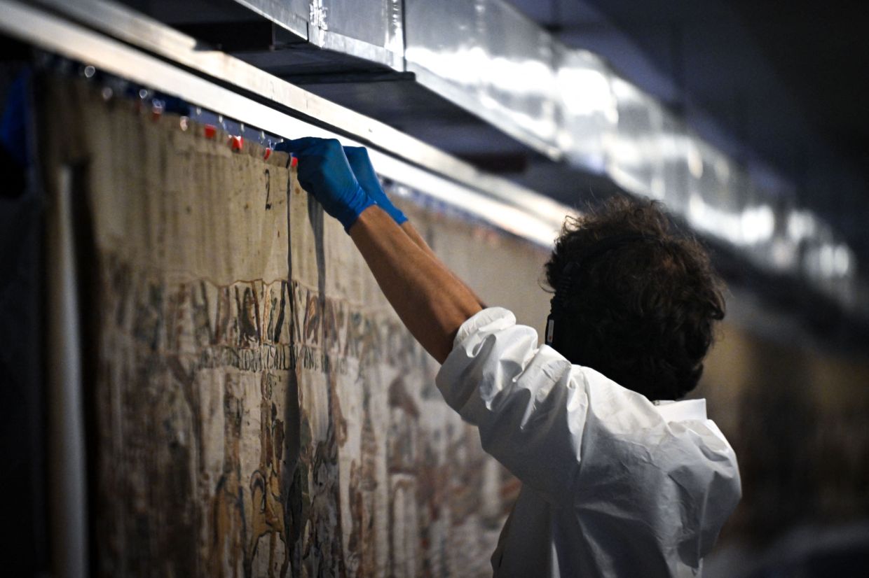 A worker prepares to pack the Bayeux Tapestry in a crate for transfer to the British Museum, at the Bayeux Tapestry Museum, in Bayeux, northwestern France. Photo: AFP