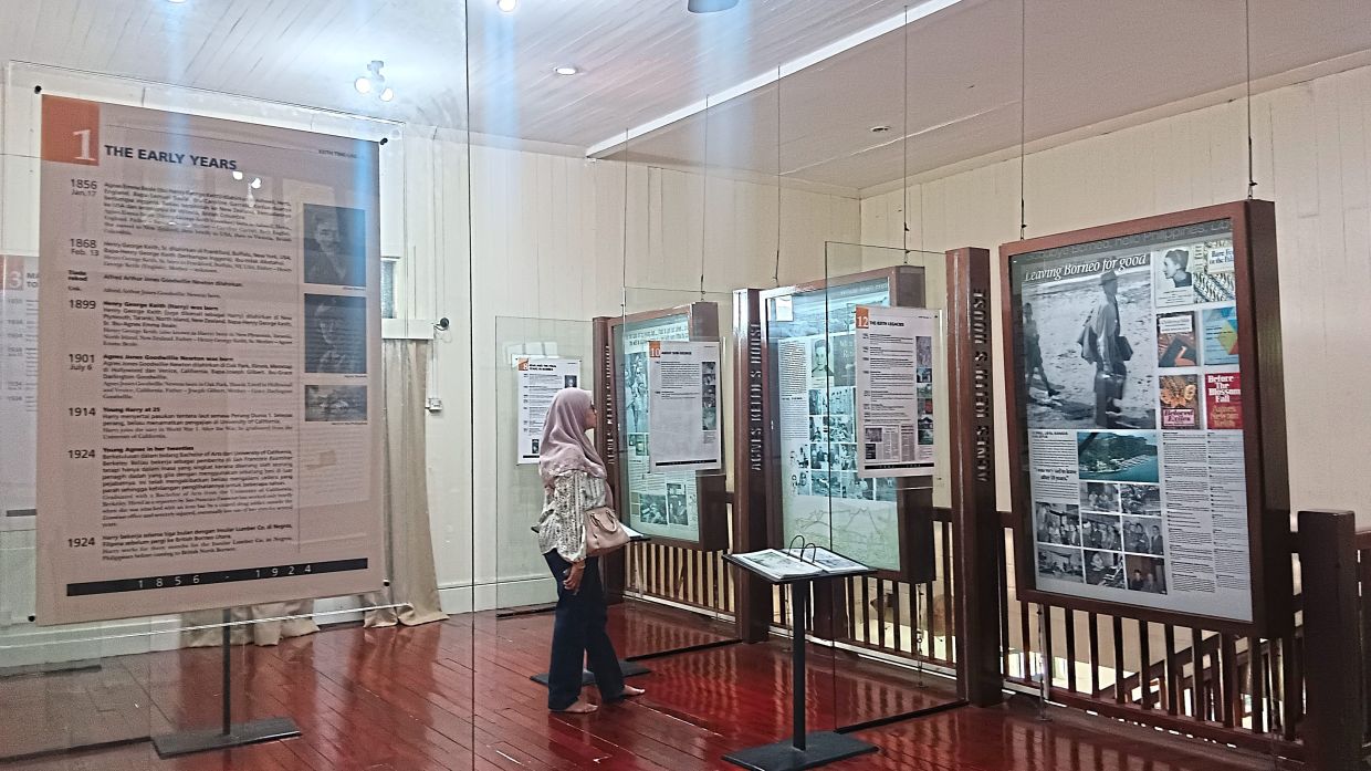 A visitor reading about the author at the restored colonial building now named Agnes Keith House (below).