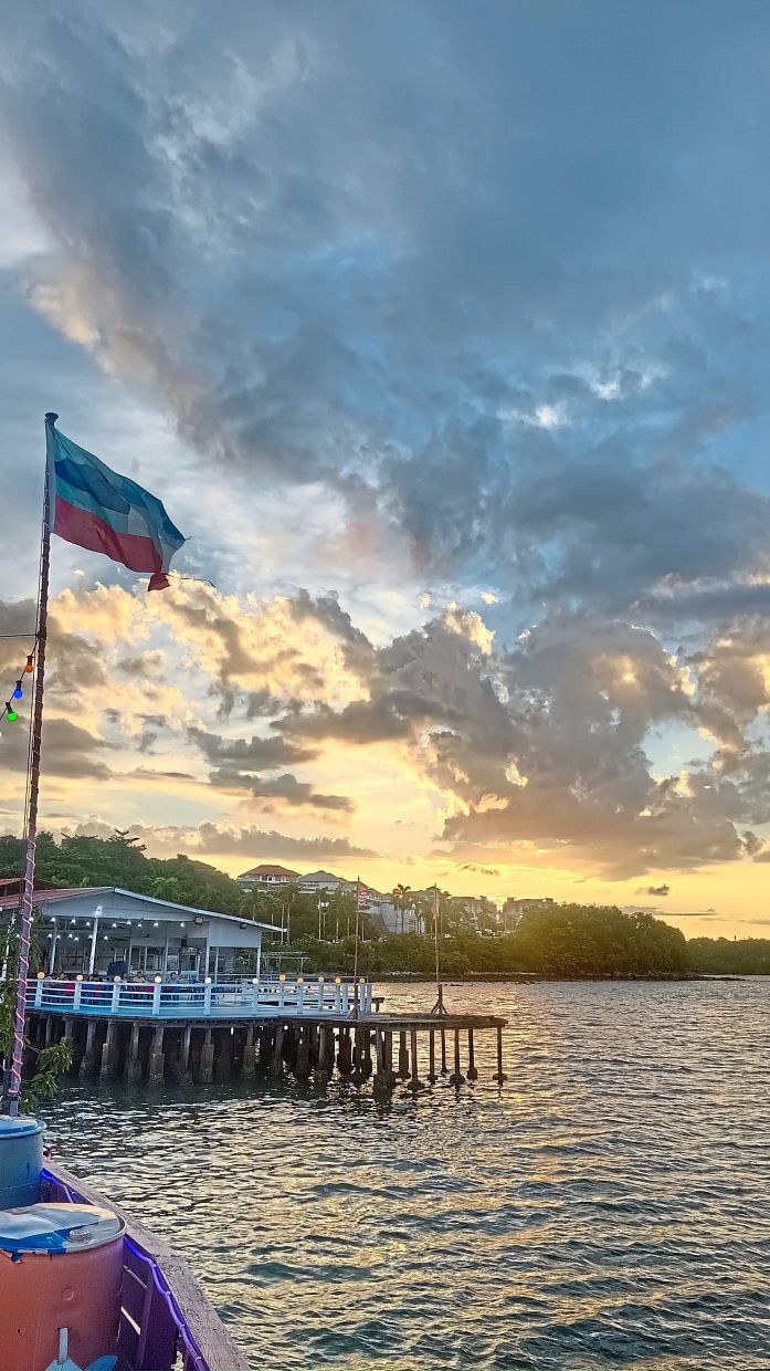 A tranquil sunset scene at Kampung Sim Sim, one of Sandakan’s iconic floating villages.