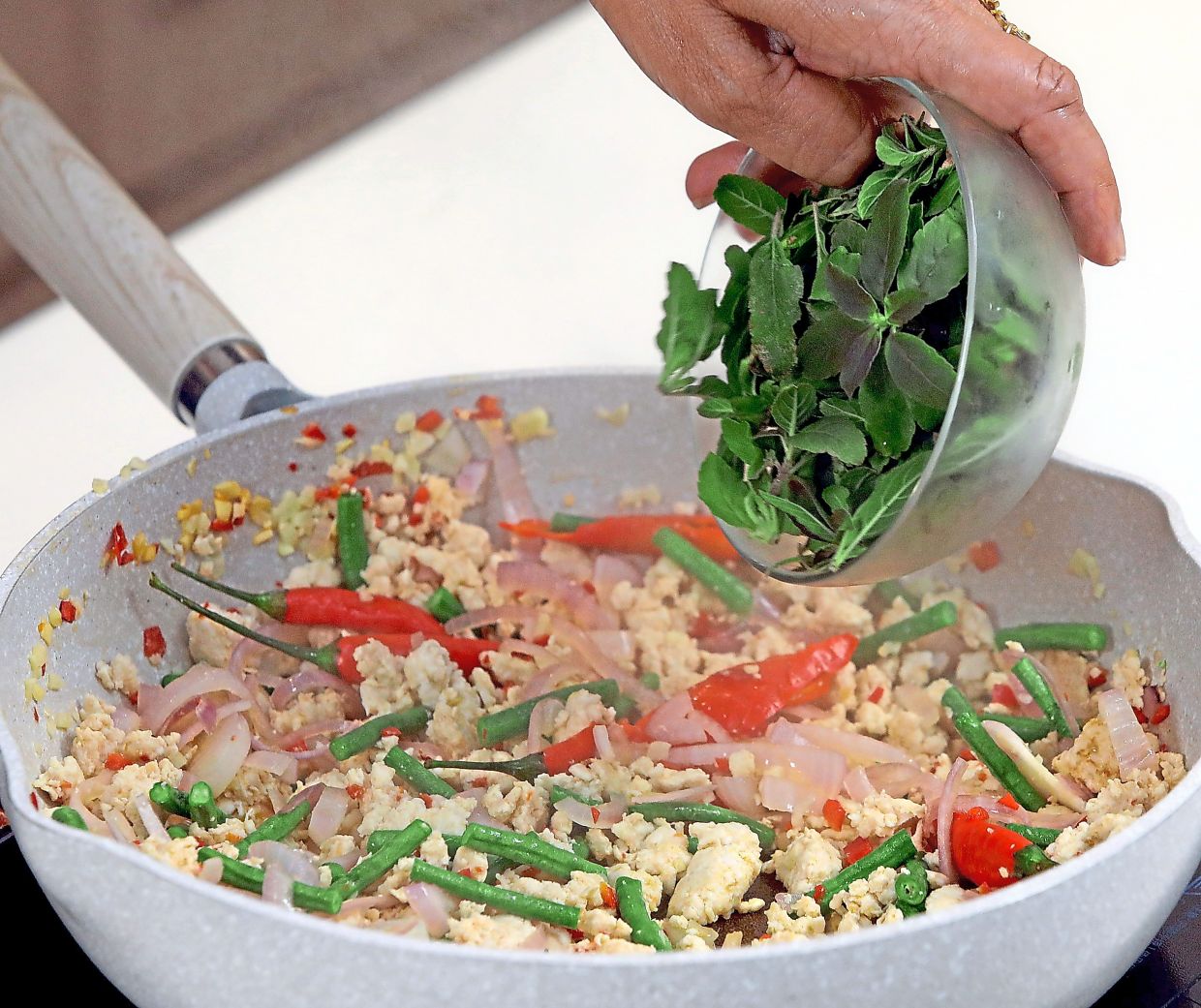 Add fresh holy basil to the dish for a lovely aroma and freshness.