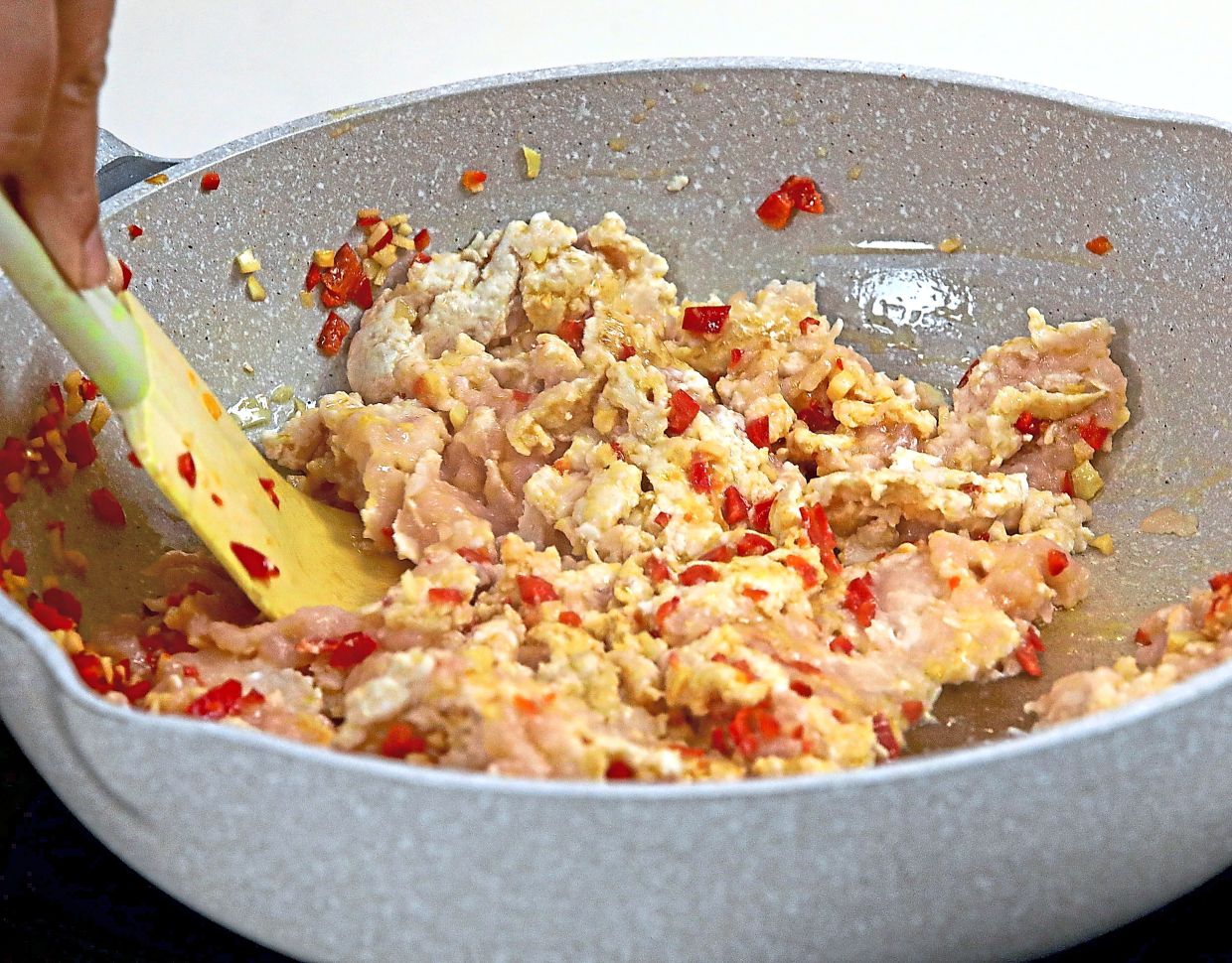 Stir and break up the minced chicken to combine with the garlic and chillies.