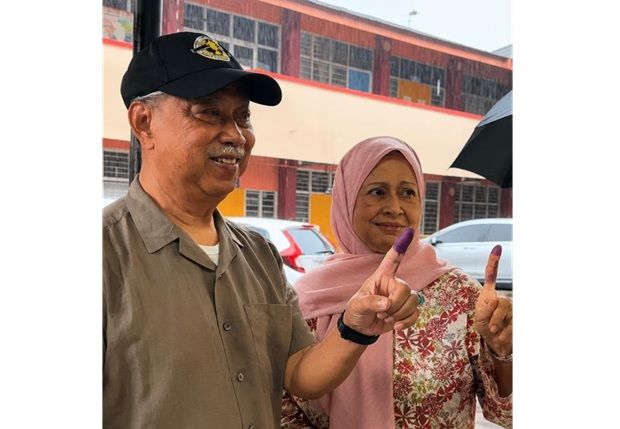 Johor polls: Muhyiddin, wife pay no heed to heavy rain to cast their ballots