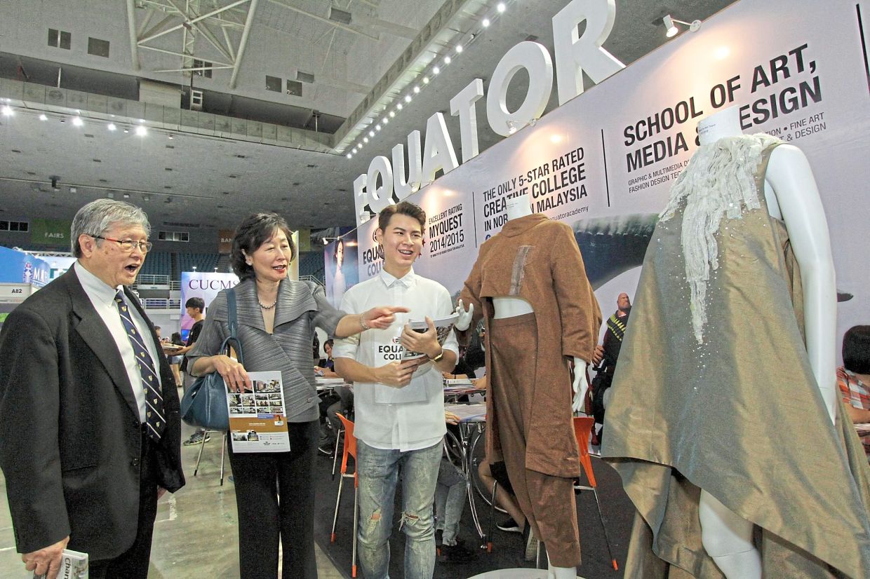 (from right) Fashion designer Michael Ooi, 22 and Goh at the Star Education Fair 2016 at SPICE Centre, Relau in Penang in 2016.—CHAN BOON KAI/ The Star