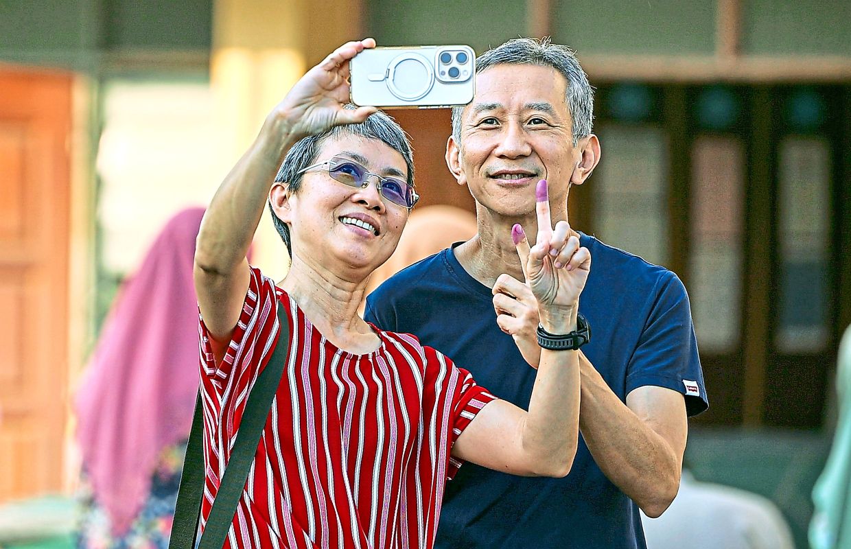 One for the album: Voters taking a selfie after casting their ballots at the SMK Bandar Baru Uda polling centre, Johor Baru. — Bernama