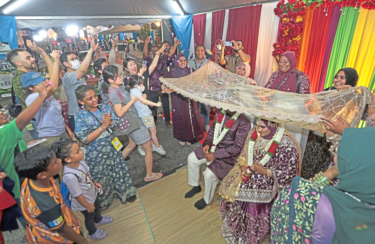 Visitors participating in a petal toss during the ‘All’s Fair in Love and Games’ activity by the Indian Muslim Community Organisation Malaysia.