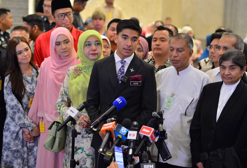 Syed Saddiq (centre) accompanied by his family, lawyers and fiancee Bella Astillah (far left). Photo: ASRIL ASWANDI SHUKOR/Sinar Daily