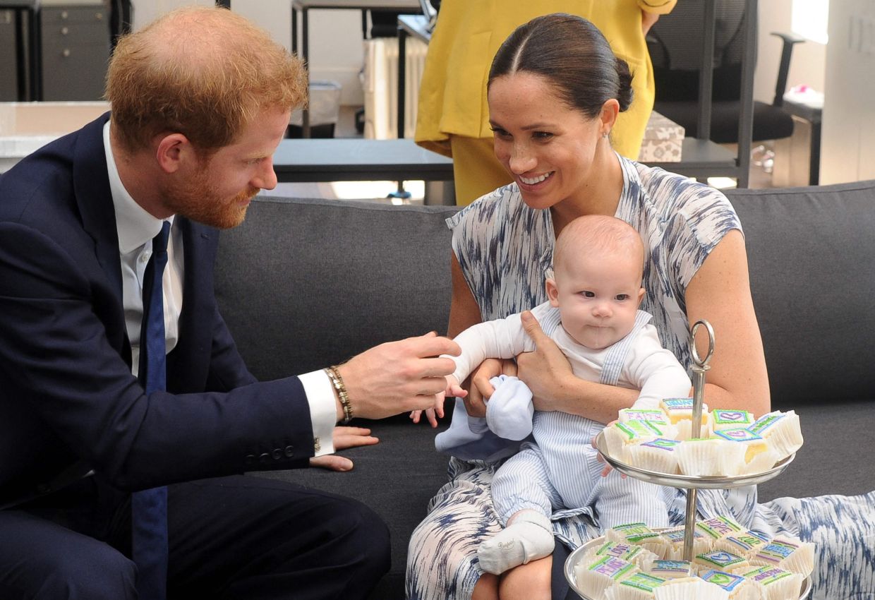 Prince Harry and his wife Meghan hold their baby son Archie in a file photo. Photo: AFP