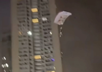 Man charged for disturbing public order in China after parachuting off residential building