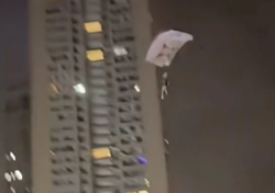 Man charged for disturbing public order in China after parachuting off residential building