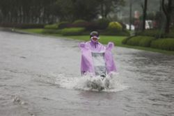 Heavy floods submerge roads and vehicles in northern China as country suffers its most powerful storm this year