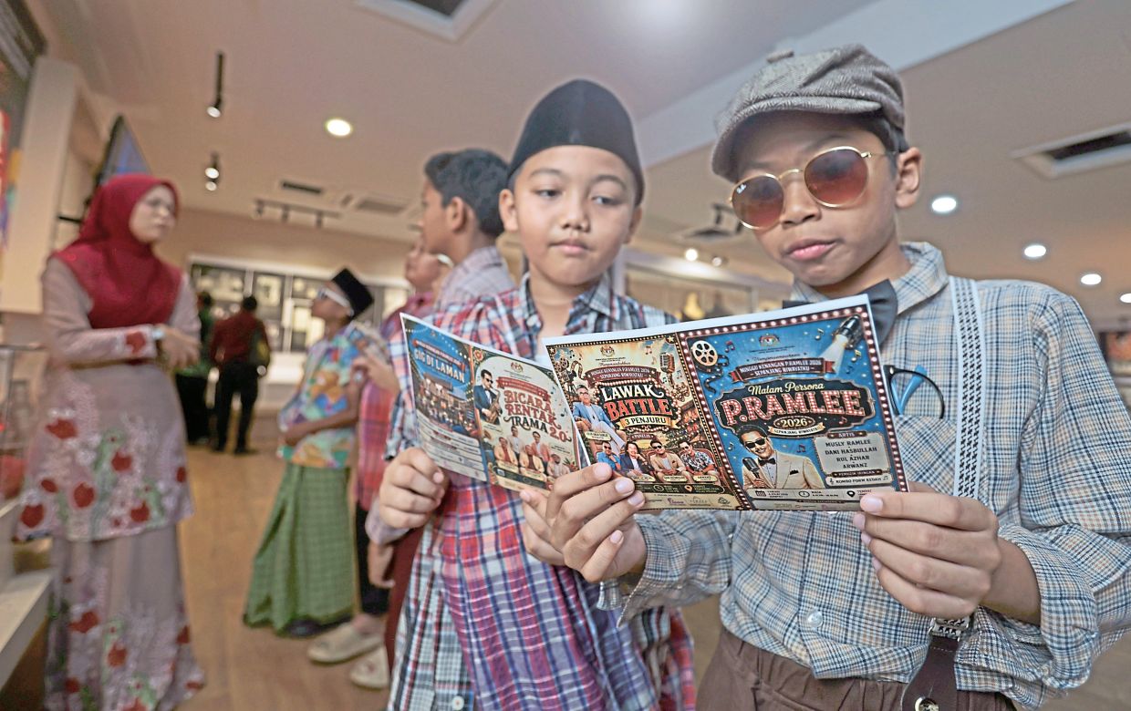 2. Year Four pupils Ilham Mansiv Mohd Hadafi (right) and Mohamad Syahmie Mohamad reading up on the life of P. Ramlee at his ancestral home that also serves as the gallery. Built in 1926, the century-old house, where P. Ramlee was born, features exhibits recreating the living areas where he grew up, alongside displays tracing his early life in Penang.