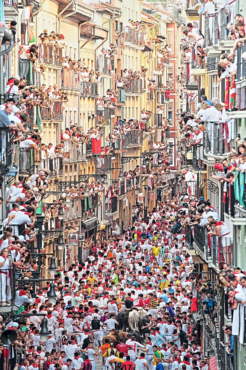 2. Revellers racing alongside Victoriano del Río’s fighting bulls during the third running of the bulls at the San Fermin festival in Pamplona. The Victoriano del Río ranch is among Spain’s most renowned breeders of fighting bulls. — AP