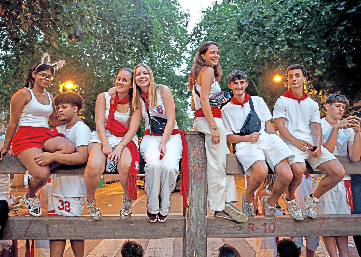 5. Festival-goers line the route ahead of the famed running of the bulls during the San Fermín festival. Dating back to the late 16th century, the annual celebration honours Pamplona’s patron saint and attracts visitors from around the world. — Reuters