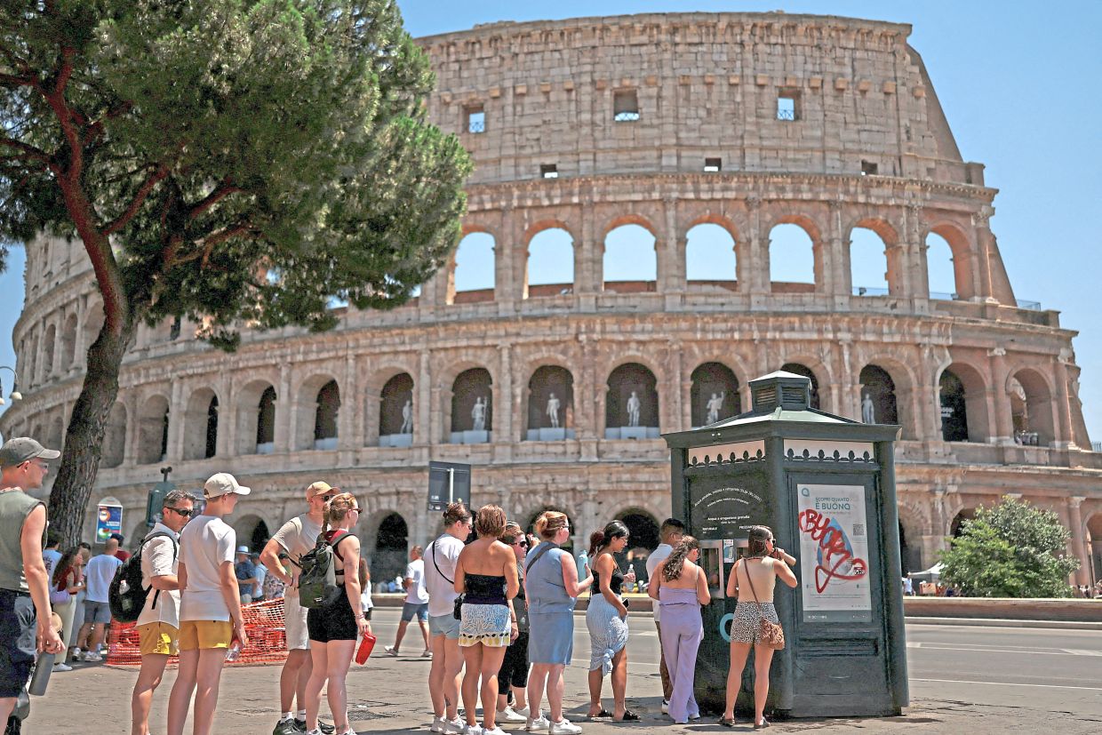 1. Visitors seeking relief from the scorching heat as they queue to refill water bottles outside Rome’s iconic Colosseum in Italy. — Reuters