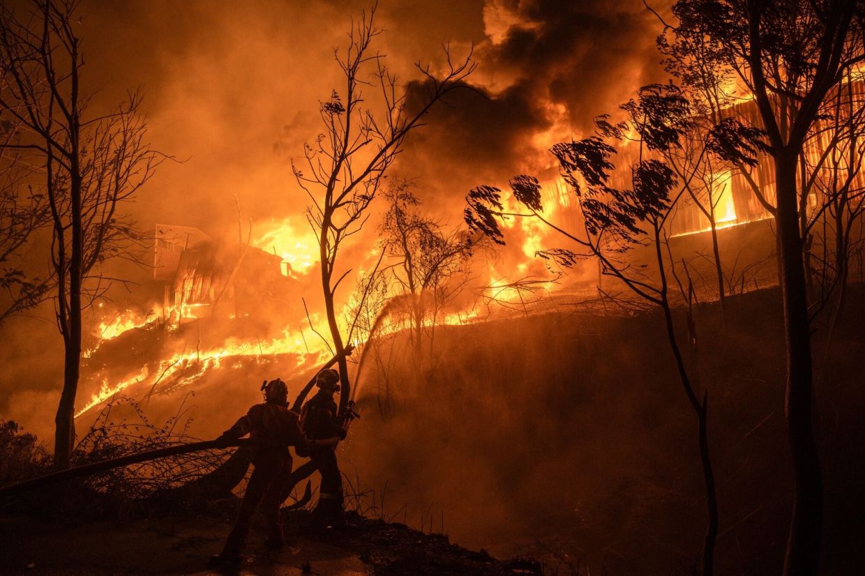 2. Firefighters battling to contain a warehouse fire during a wildfire near Oraiokastro, on the northwestern outskirts of Thessaloniki, Greece. Record-breaking heat and scarce rainfall have turned forests and fields into tinderboxes, with forecasters warning of more extreme conditions ahead. — Bloomberg