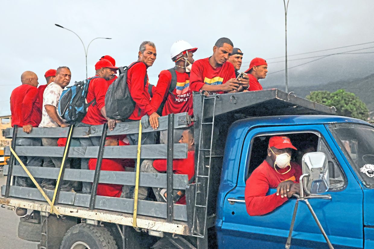 7. Workers ride atop a lorry through La Guaira as recovery efforts press on across the quake-hit region. — Reuters