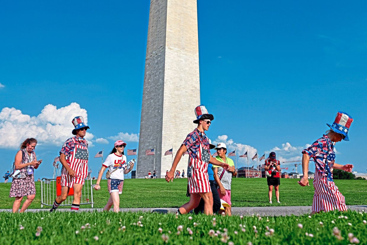3. Revellers dressed in stars and stripes arrive for the salute to America Independence Day celebration in Washington, DC.