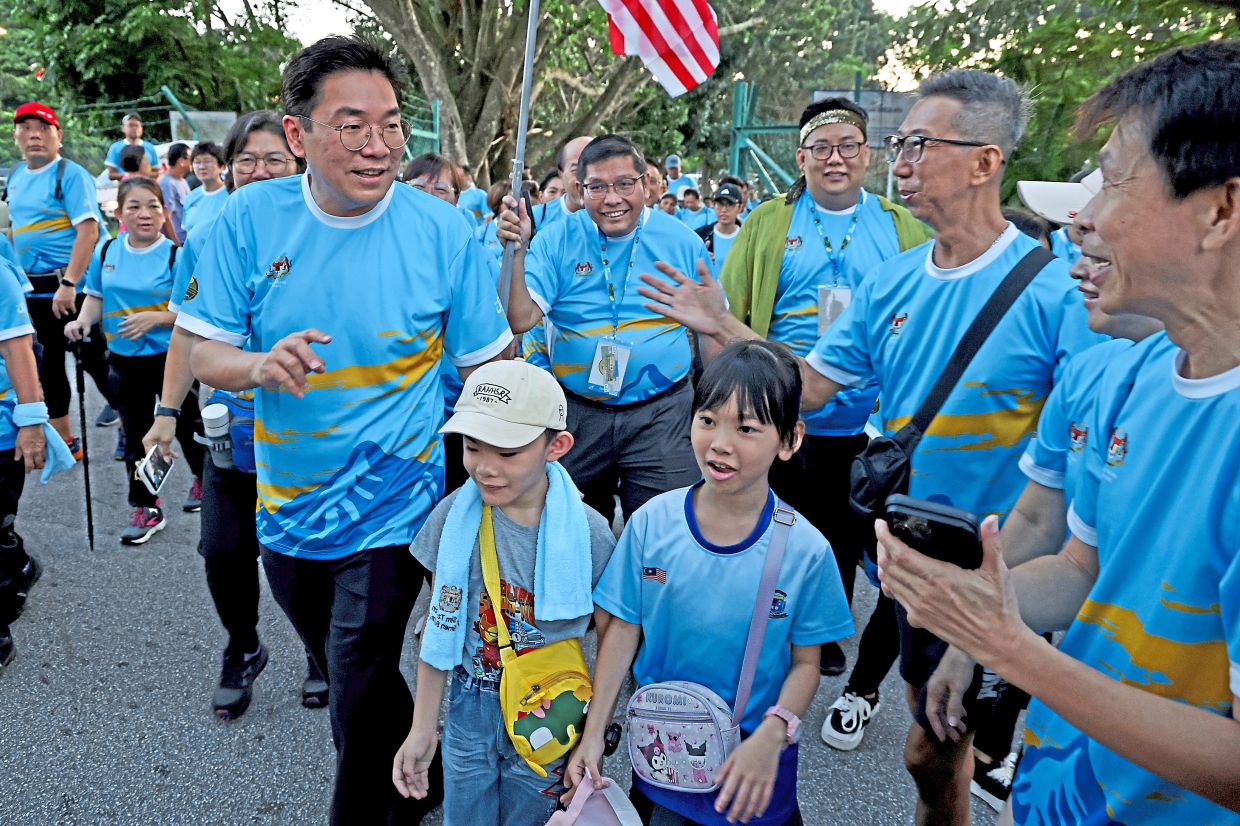 Sim (left) joining participants of the Sungai Ara Hiking cum Durian Feast.