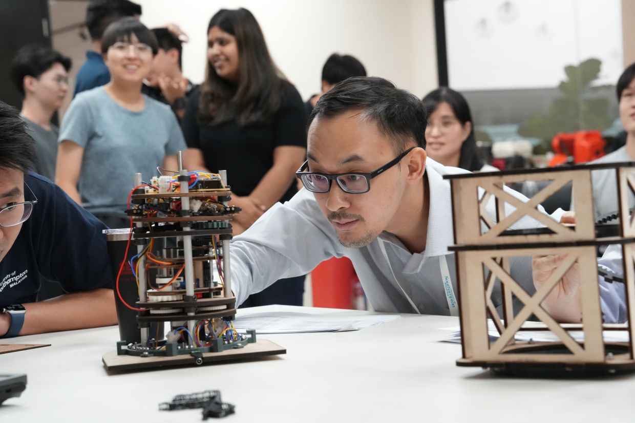 Students learn alongside a UoSM lecturer during a practical engineering session.