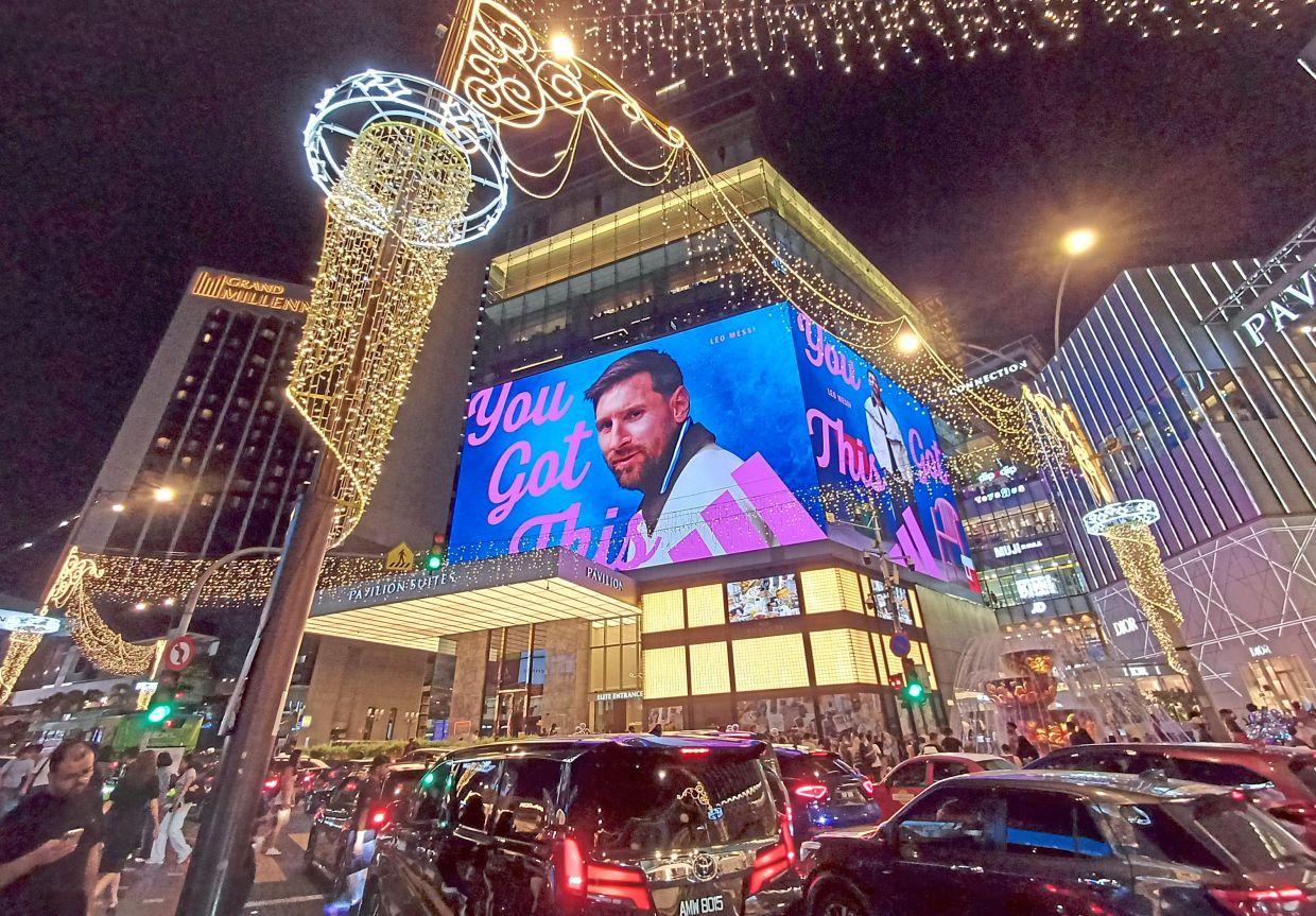 A giant digital billboard featuring Argentina captain Lionel Messi lights up Bukit Bintang, drawing football fans and passers-by as FIFA World Cup excitement continues in Kuala Lumpur. — ART CHEN/The Star