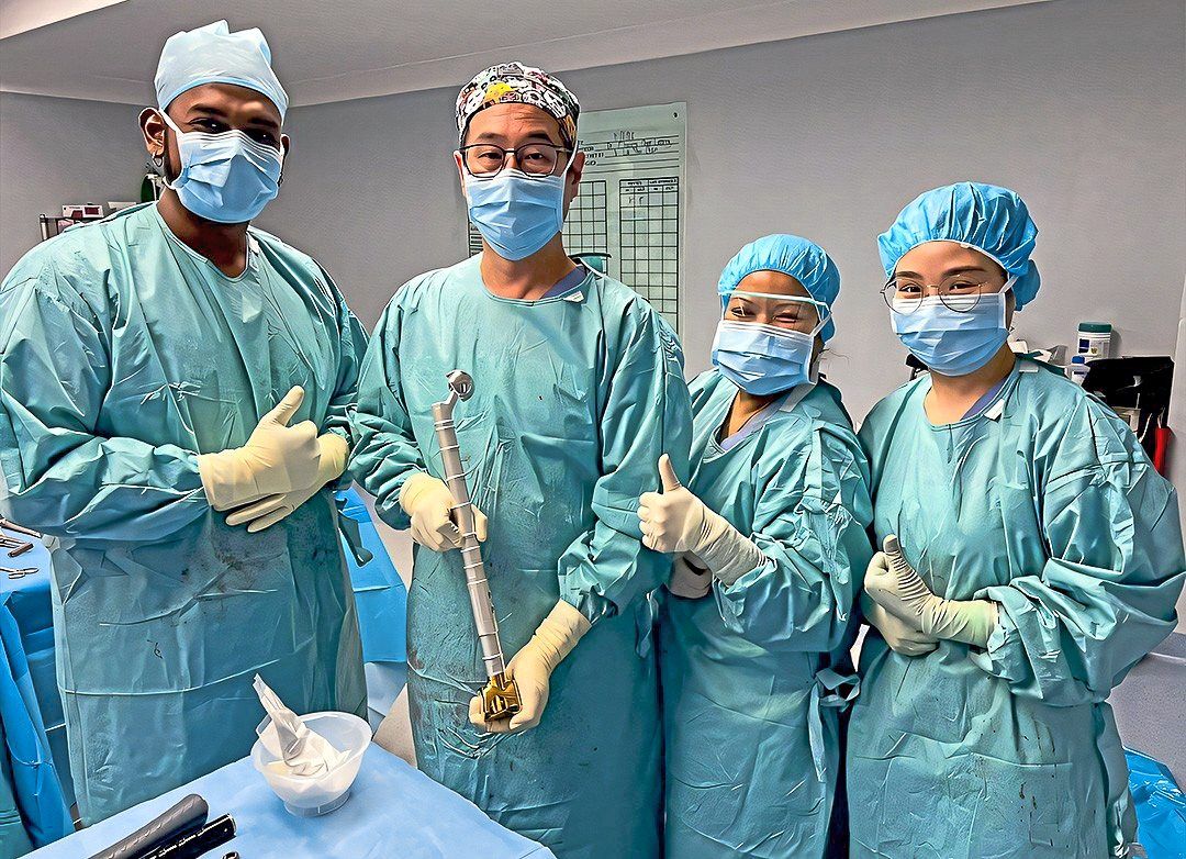 Dr Choong and his team ready to proceed with the surgery to implant this silver megaprosthesis in Tham's leg. — Beacon Hospital