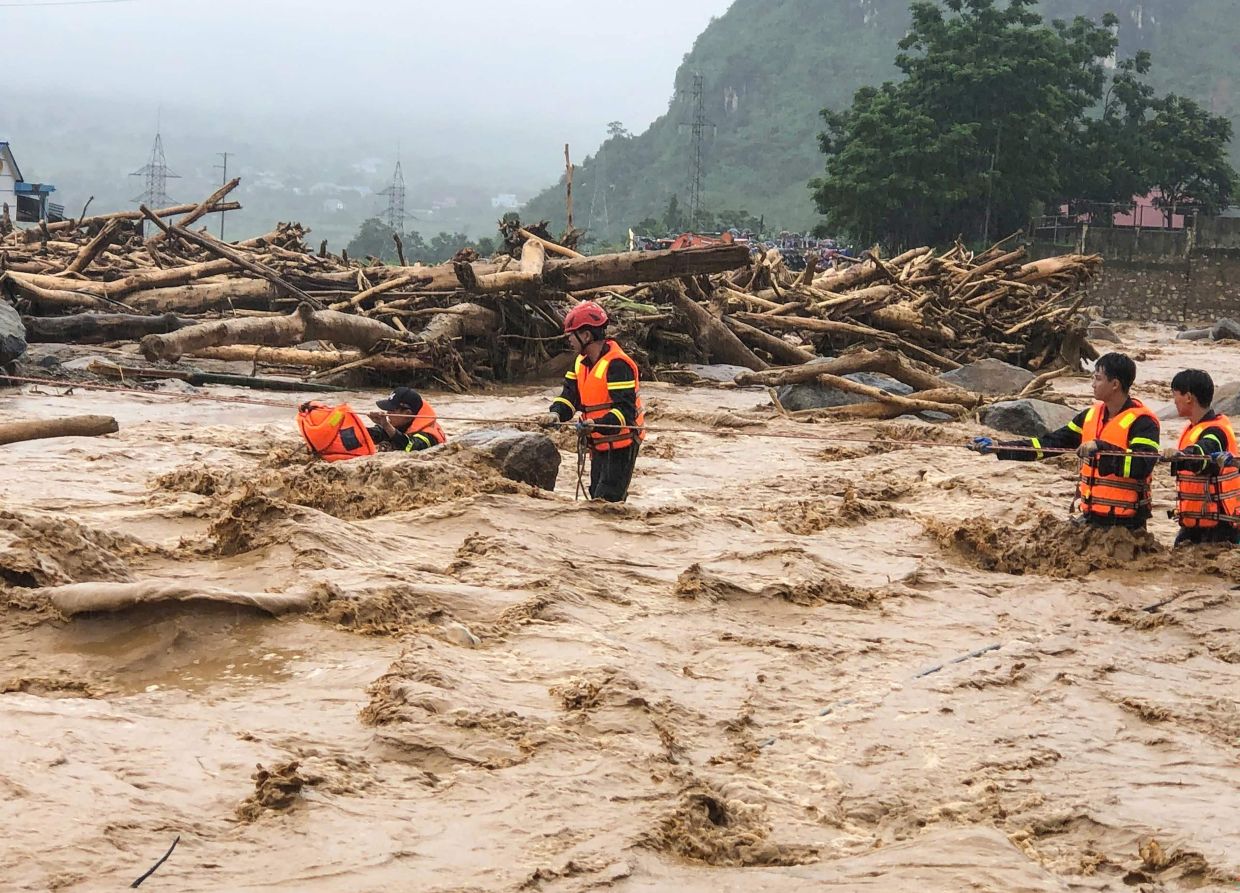 This photo, taken and released by Vietnam News Agency (VNA) on Friday, July 17, 2026, shows rescue workers addressing the aftermath of flash floods in Muong Than Commune, Lai Chau Province, northern Vietnam. -- Photo by Vietnam News Agency (VNA) / AFP