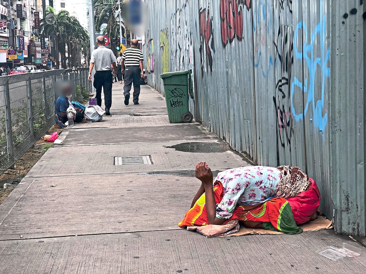 Alongside the luxury boutiques, five-star hotels and glittering facades of Bukit Bintang is the sight of beggars occupying some of the busiest pedestrian areas. — Filepic