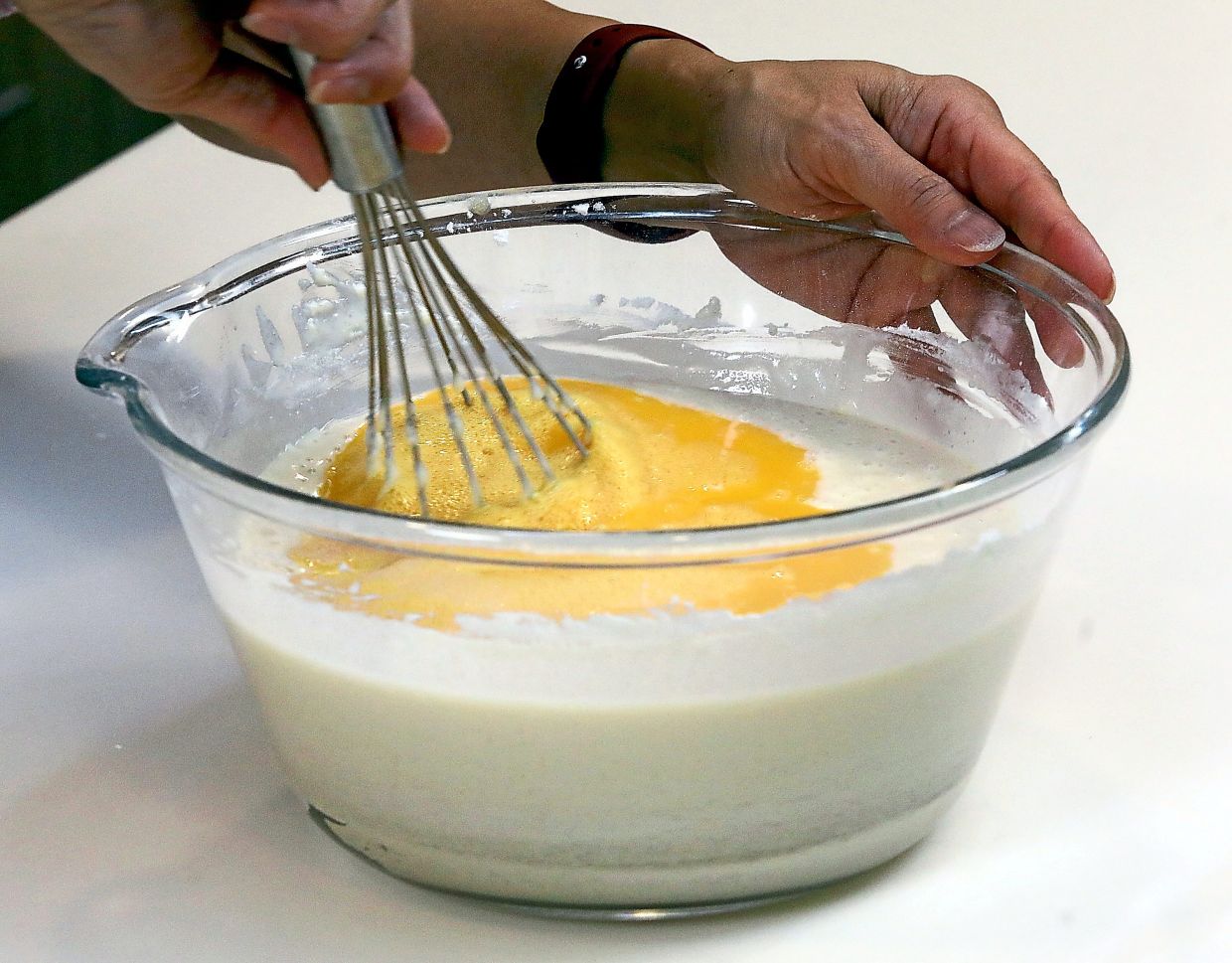 Batter of glutinous rice flour, brown sugar, baking powder, milk, oil and beaten eggs comes together in about 30 minutes.