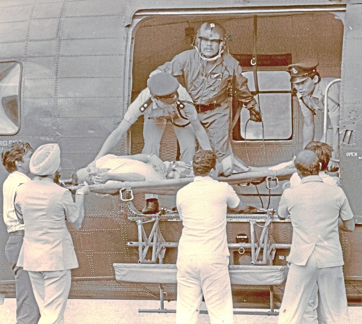 An injured policeman is airlifted to a hospital by helicopter for further treatment in this photo dated Nov 20, 1985. — The Star
