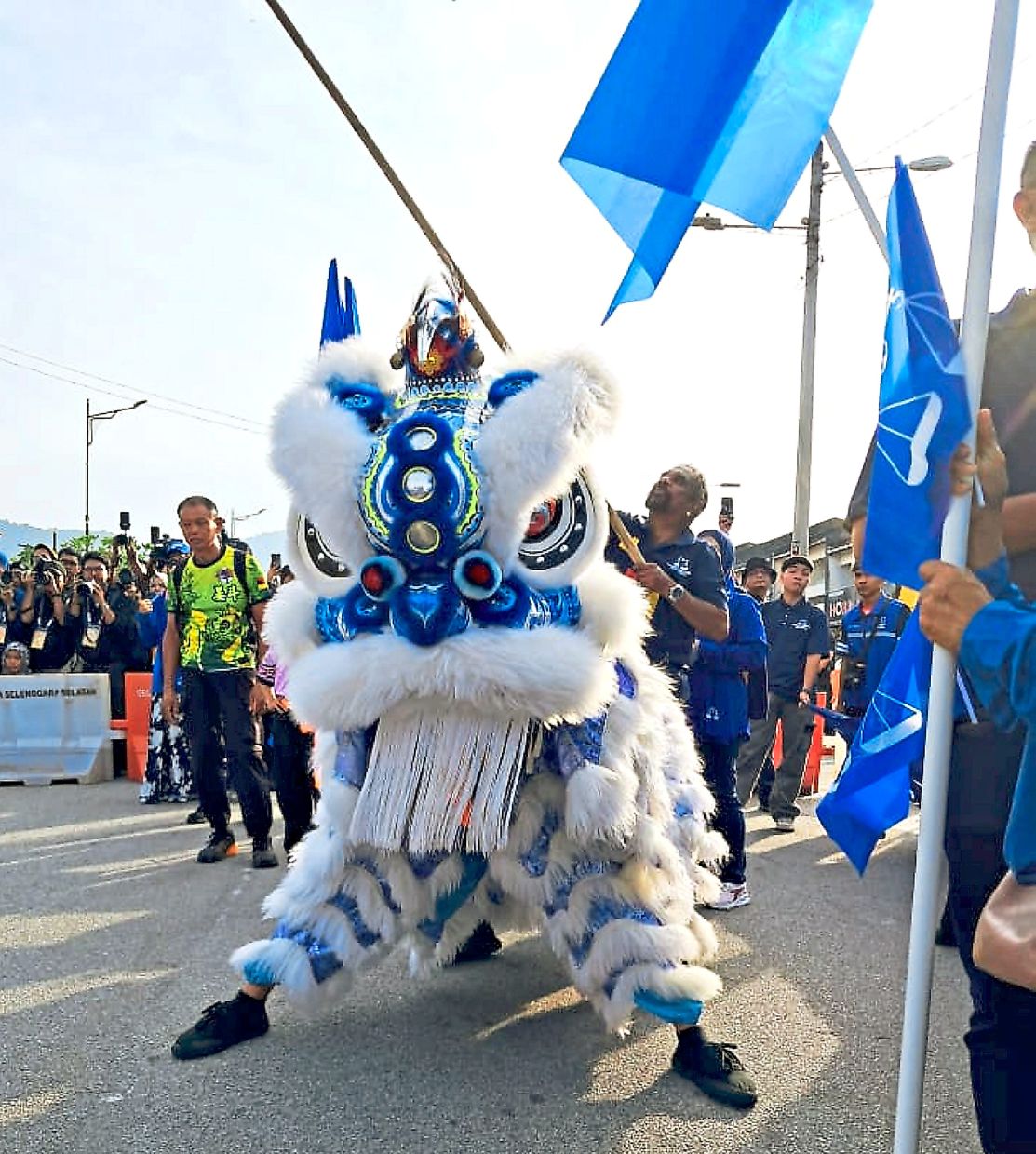 A lion dance troupe accompanying Barisan candidates in Rembau. — GERARD GIMINO/SARBAN SINGH/The Star