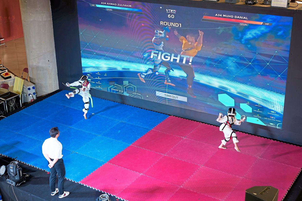 Virtual taekwondo athletes compete at an event in Kuala Lumpur.