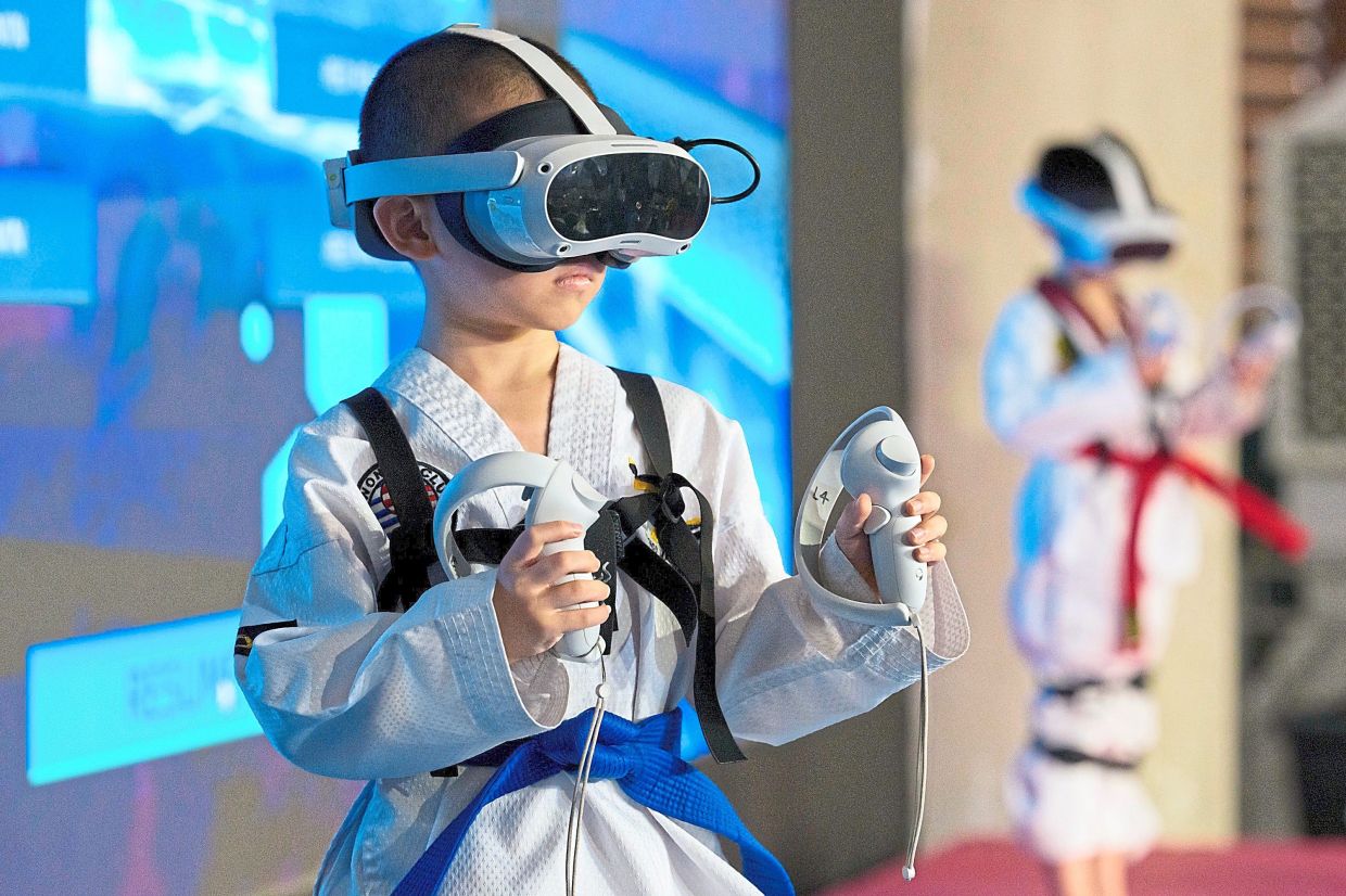 A young virtual taekwondo athlete competes during a taekwondo competition.