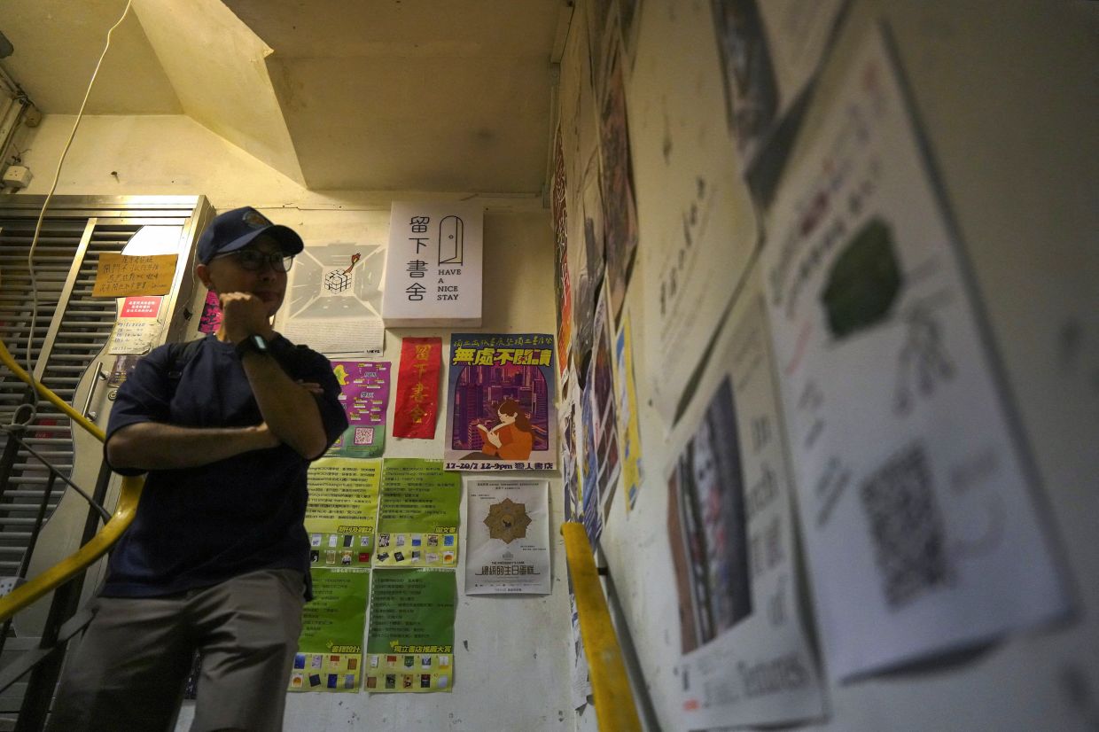 A visitor walks past the closed Have a Nice Stay bookstore after booksellers were arrested by national security police on suspected charges of 'doing an act with seditious intention' in Hong Kong on July 16. Photo: Reuters 