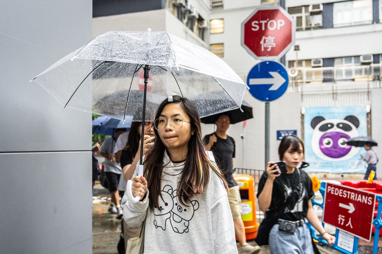 Mandy Lau, a bookseller of Have A Nice Stay bookstore, who was earlier arrested by the police, leaves a police station in Cheung Sha Wan, Hong Kong on July 17. Photo: AP