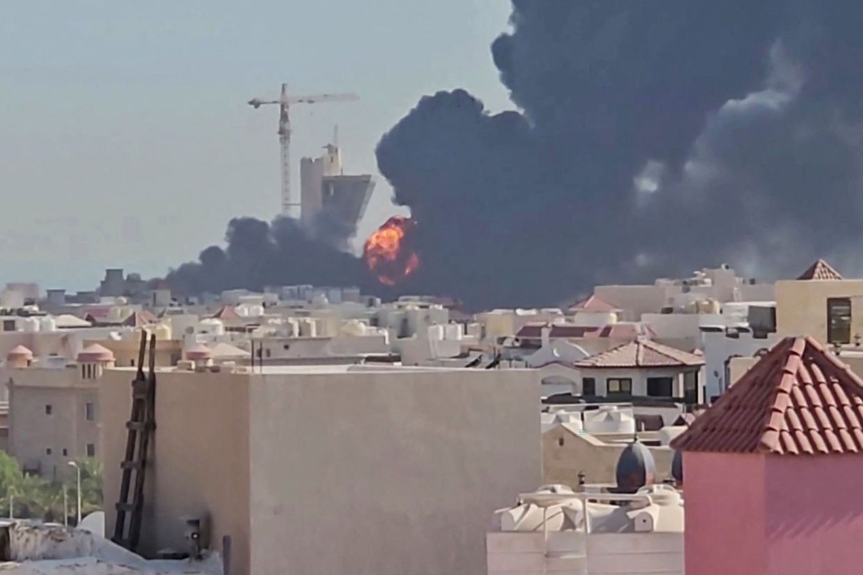 This screen grab, taken from UGC video footage posted on social media on July 18, 2026, shows a plume of black smoke and flames billowing over the town of Mangaf, south of Kuwait City. Kuwait accused Iran on July 18 of targeting civilian sites and vital infrastructure in the country, after reporting attacks on an oil facility and a power and water plant. -- Photo by various sources / AFP