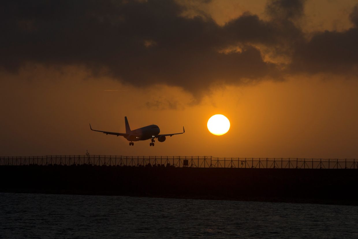 A passenger jet lands at I Gusti Ngurah Rai International Airport during sunset in Badung, Bali, Indonesia, on Sunday, July 19, 2026. -- AP Photo/Firdia Lisnawati