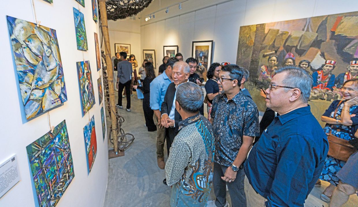 Visitors looking at the expedition’s sketches and paintings during the special preview.