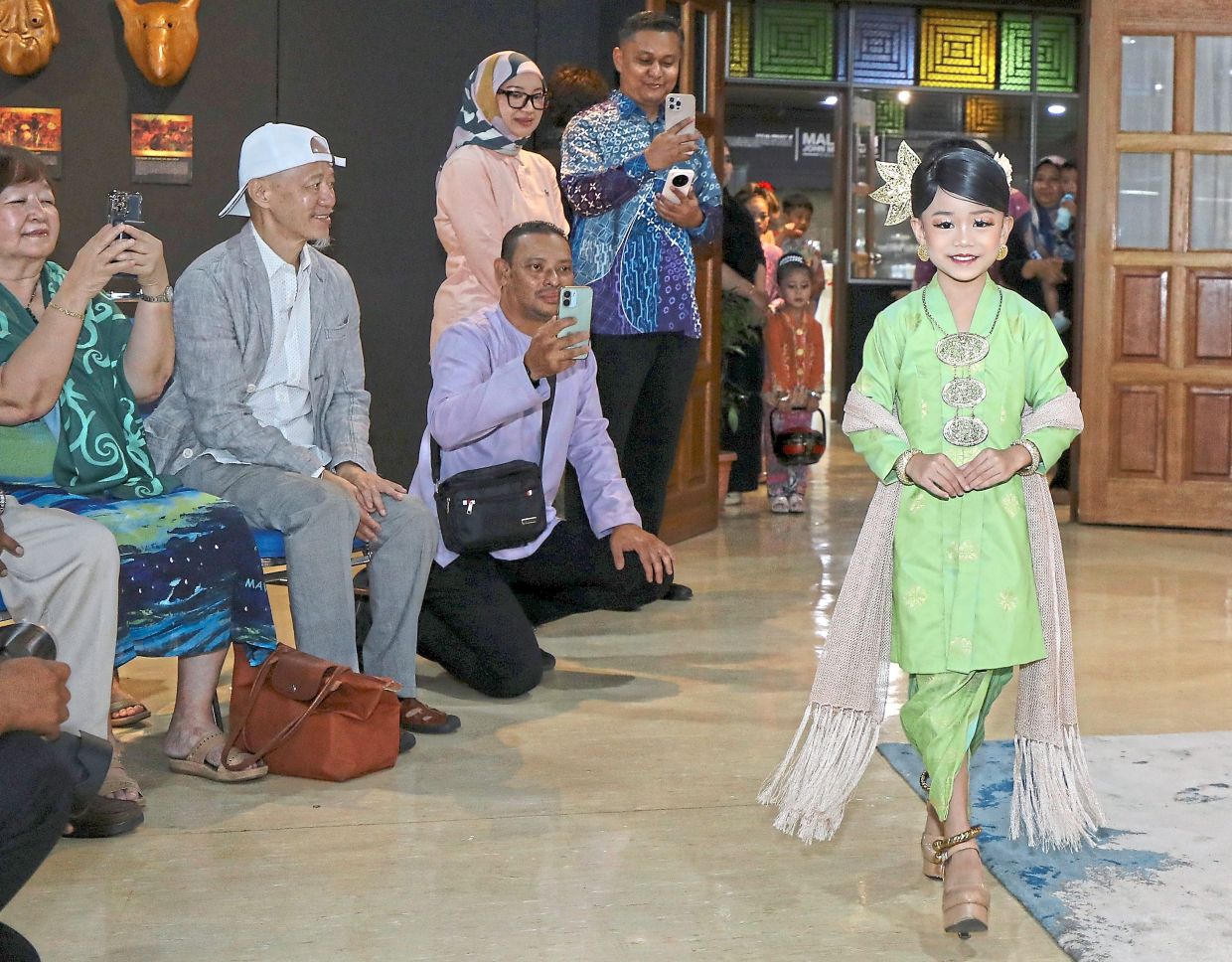 The kebaya can be enhanced with accessories such as shawls and jewellery, as seen here at the exhibition’s launch.