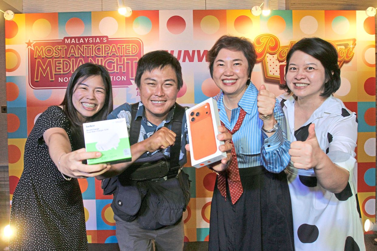 Lim (second from left) posing with his grand prize alongside (from left) Liew, Lee and Abbey.