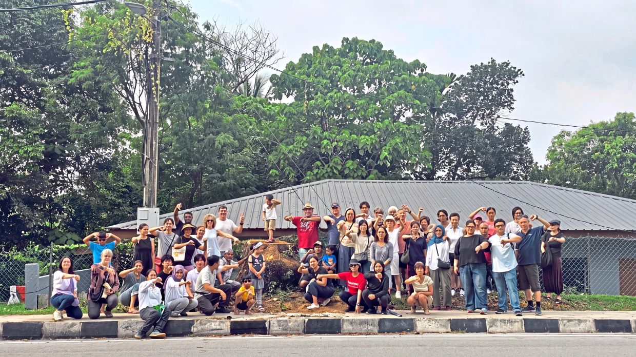 Residents living around Jalan Kerja Air Lama in the Ampang Jaya municipality gathering to show their discontent over the cutting of a 100-year-old raintree last month. — Handout