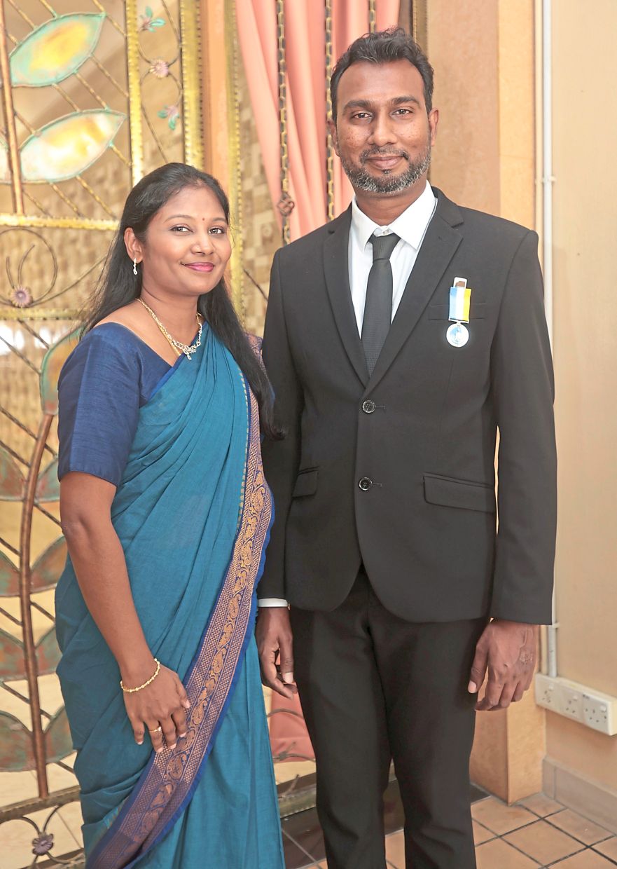 Pingat Jasa Kebaktian (PJK) recipient Thanabalan with wife Shanti Malar Ramanathan.