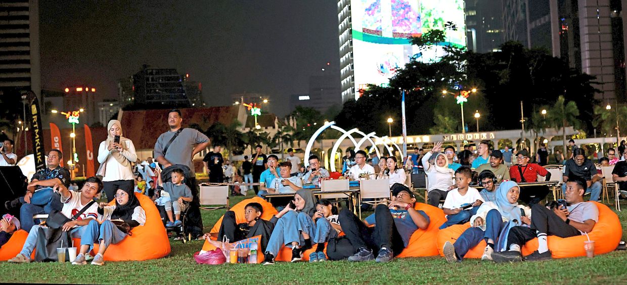 The final countdown: People gathering at Dataran Merdeka for the FIFA World Cup final. — CHAN TAK KONG/The Star