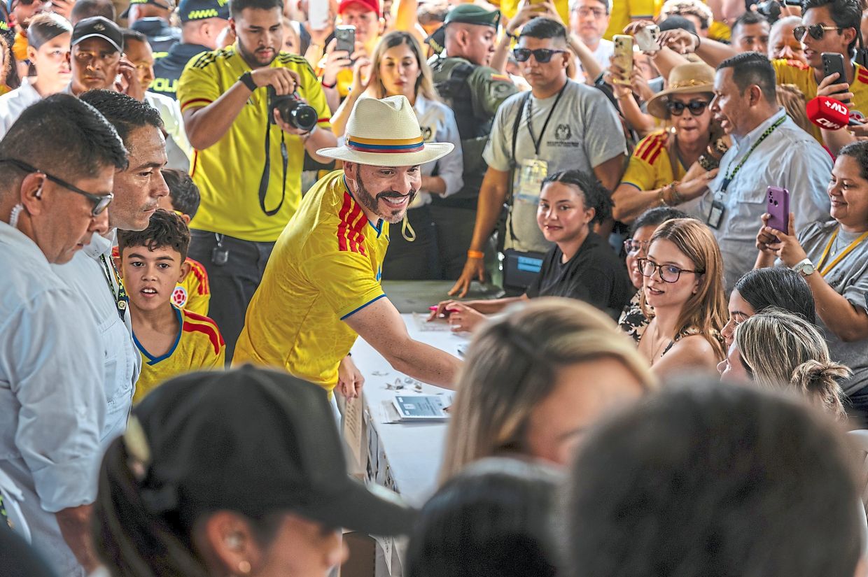 De la Espriella, heavily escorted and surrounded by supporters, casting his vote.— Federico Rios/The New York Times