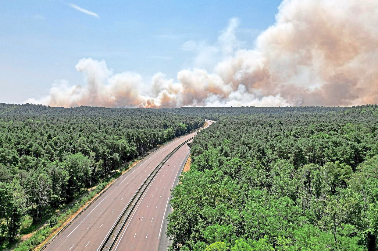A drone view of plumes of smoke billowing over the empty A6 highway in France.