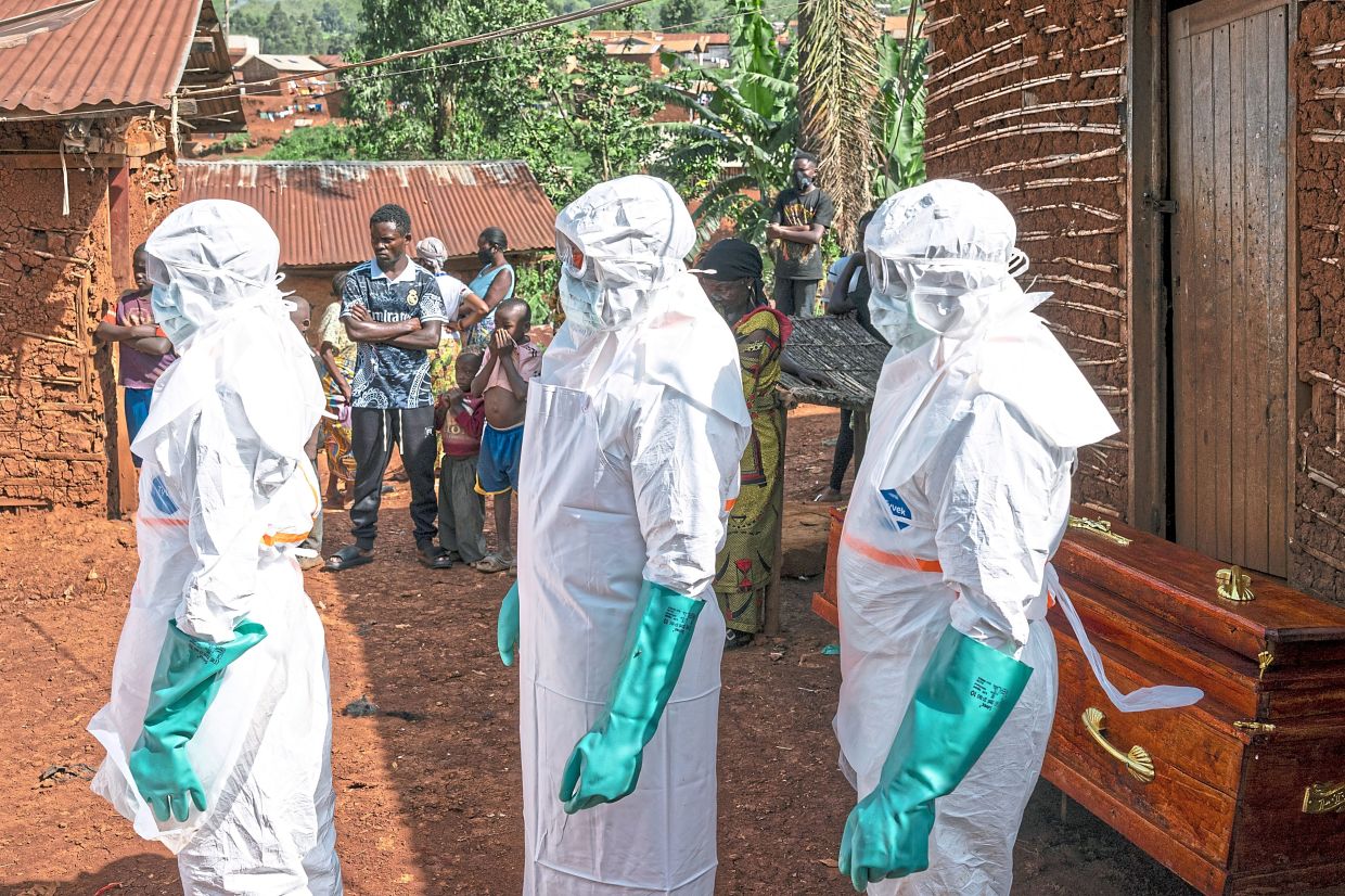 A file photo of health workers removing the body of a person whose suspected cause of death was Ebola, in Mongbwalu, Democratic Republic of Congo, on May 24. — Arlette Bashizi/The New York Times