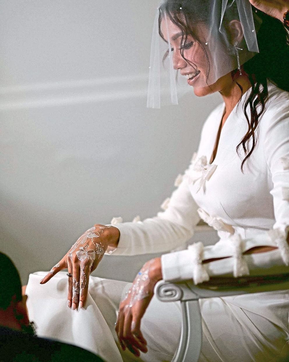 Mimi is shown here wearing a fun bridal design covered in bows by Nurita Harith. Photo: Instagram/Mimi Lana
