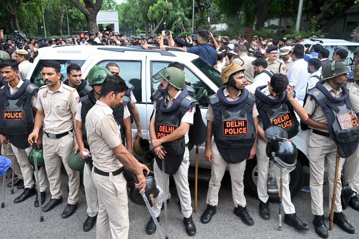 Police personnel standING guard as India's opposition party Indian National Congress stages a sit-in protest calling for Prime Minister Narendra Modi's resignation outside the latter's residence in New Delhi on July 21, 2026, a day after police crackdown against the protesting Cockroach Janta Party (CJP) supporters demanding the Education Minister Dharmendra Pradhan step down over alleged NEET examination irregularities. -AFP