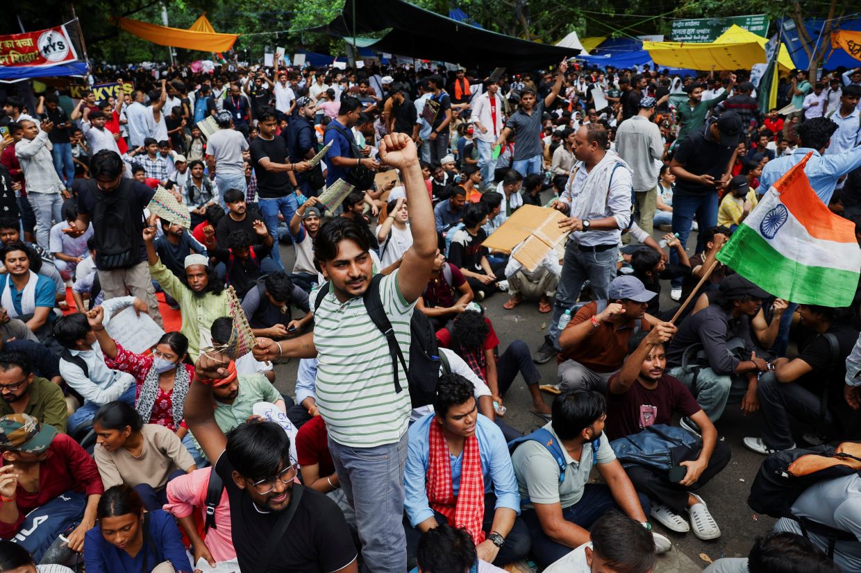 Supporters of India's Cockroach Janata Party chanting slogans during the ongoing protests, two days after thousands of protesters marched towards parliament demanding the resignation of Education Minister Dharmendra Pradhan over examination paper leaks, at Jantar Mantar in New Delhi on July 22, 2026. - Reuters