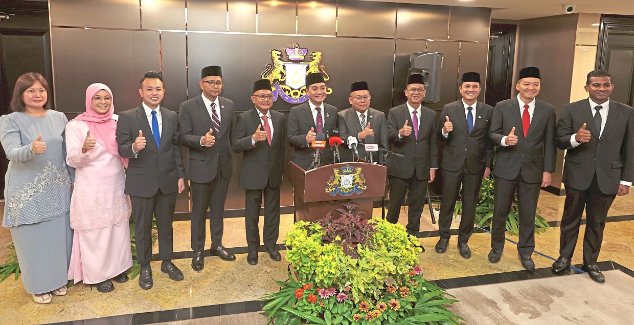 New faces: Onn Hafiz (centre) posing for a photo with the 10 newly appointed deputy state executive councillors. — THOMAS YONG/The Star