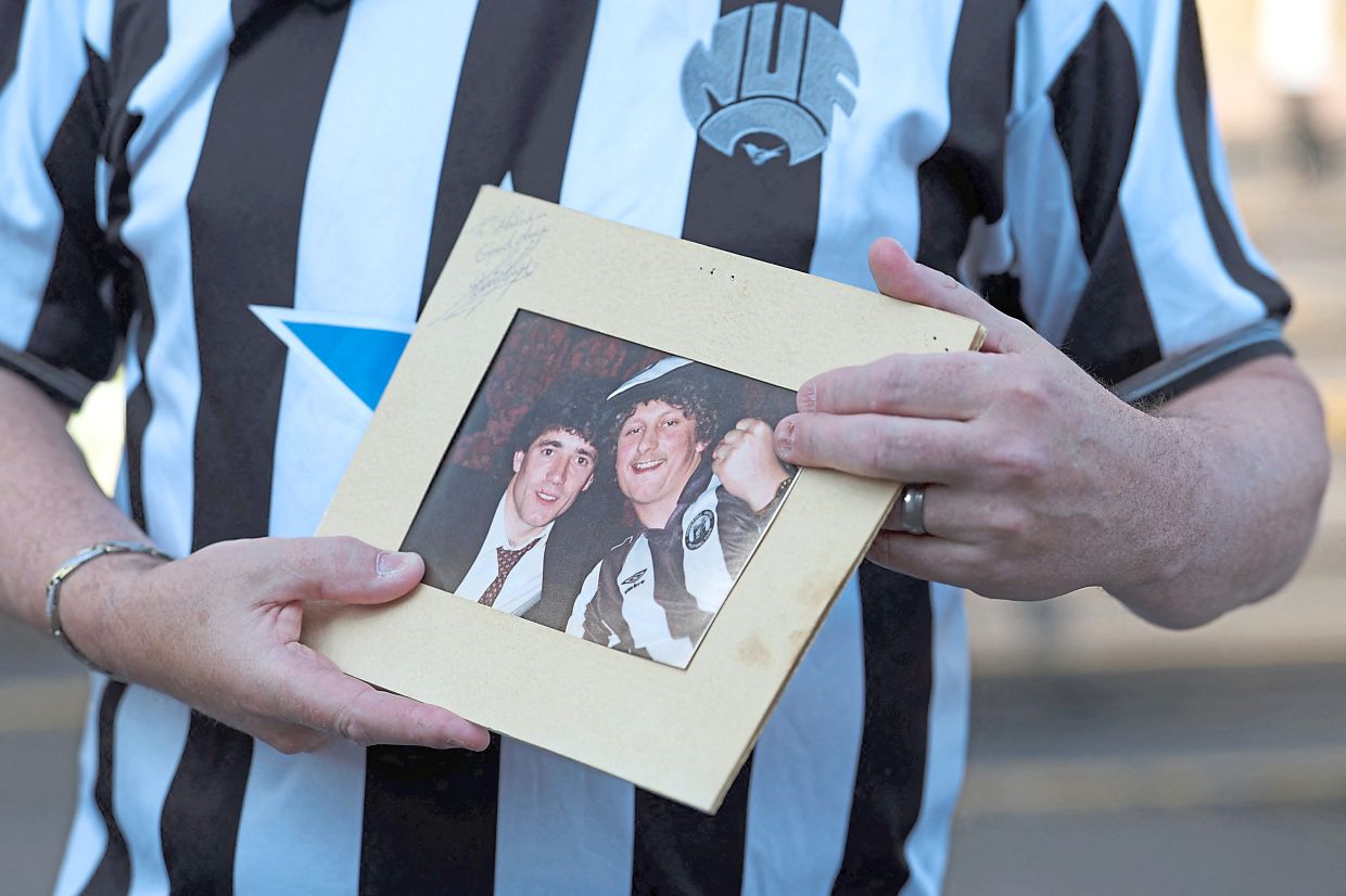 Newcastle United fan Malcolm Shield shows a picture of himself with Keegan.